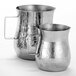 An American Metalcraft silver hammered stainless steel bell creamer. A close-up of a silver pitcher.