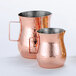 Two American Metalcraft copper hammered stainless steel bell creamers with handles.