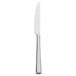 A silver Walco stainless steel steak knife with a white handle.