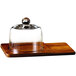 An American Atelier wood cheese board with glass dome on a wooden tray.