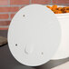 A white vented paper lid on a white food bucket.