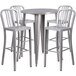 A Flash Furniture silver metal bar height table with four vertical slat back stools around it.