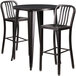 A Flash Furniture black metal bar height table with 2 chairs with black vertical slat backs.