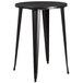 A Flash Furniture round black metal table with legs.
