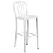 A white metal bar stool with a vertical slat backrest.