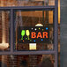 A Choice LED rectangular bar sign in a window above a couple of glasses.