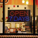 A rectangular LED sign that says "Open 7 Days" with lights on it.
