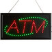 A rectangular LED sign with "ATM" in red and green lights.