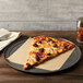An American Metalcraft galvanized pizza pan with a slice of meat and onion pizza on a plate.