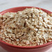 A bowl of Bob's Red Mill gluten-free whole grain rolled oat flakes.