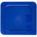 A blue plastic lid with a black and white label covering a blue plastic container.