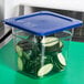 A Carlisle Smart Lid 1/6 size soft food pan cover on a container of sliced cucumbers.