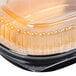A Durable Packaging Black and Gold aluminum foil take-out pan with a clear plastic lid.