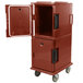 A red plastic Cambro Ultra Camcart food pan carrier with the door open.