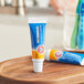 An Arm & Hammer toothpaste tube on a wood surface.