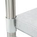An APW Wyott stainless steel equipment stand with a metal pole on a metal shelf.