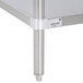 A wood top work table with a stainless steel undershelf.
