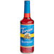 A Torani sugar-free raspberry syrup in a glass bottle with a blue label.