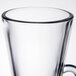 A close up of a clear Libbey glass coffee mug with a handle.