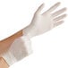 A person wearing Noble Products large powdered disposable latex gloves.