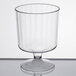 A clear WNA Comet Classicware plastic wine cup with a small pedestal base on a white surface.