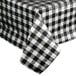 A black and white checkered Intedge vinyl table cover on a table.