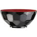 A close-up of a black bowl with a red rim.