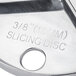 A stainless steel Waring 3/8" slicing disc with a circular hole.