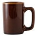 A brown Tuxton china mug with a handle.