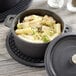 An American Metalcraft pre-seasoned cast iron pot filled with pasta, broccoli, and chicken.