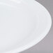 A close up of a Cambro Classic White Ceramic Plate with a rim.
