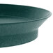 A close-up of a green polypropylene round deli server with a metal rim.