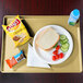 A tray with food including a sandwich, chips, and a drink on it.