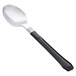 A WNA Comet Reflections Duet stainless steel look teaspoon with a black handle.