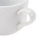 A close-up of a white CAC Times Square coffee cup with a handle.