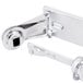 A San Jamar chrome metal locking toilet paper holder with a latch.