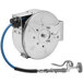 A T&S stainless steel hose reel with a silver and blue hose attached.