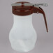 A white plastic Tablecraft syrup dispenser with a brown handle and lid.