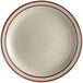 An Acopa stoneware plate with a white background and brown speckled border.