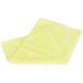 A folded yellow Unger SmartColor Microfiber Cleaning Cloth on a white surface.