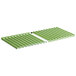 Two green plastic grilling racks with holes on a white background.