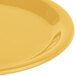 A close up of a Carlisle honey yellow narrow rim pie melamine plate.