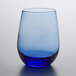 A close up of a Libbey Tidal Blue stemless white wine glass with a blue rim.
