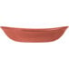 A white melamine serving bowl with a red rim.
