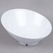 A white GET San Michele slanted bowl on a gray surface.