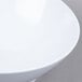 A white GET San Michele slanted bowl on a gray surface.