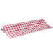 A roll of red and white checkered paper table cover with red gingham pattern.