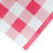 A red and white checkered paper table cover with a gingham pattern.