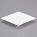 A white porcelain coupe dinner plate with a square cut.