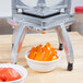 A Nemco Easy Chopper II on a table with bowls of sliced orange peppers and tomatoes.